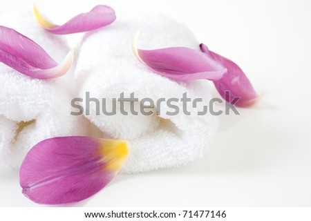 White towels with the petals on a white background