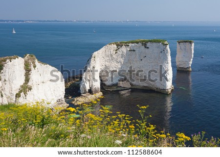 The Old Harry Rocks are chalk formations, located at Handfast Point, on the Isle of Purbeck in Dorset, southern England. (With Bournemouth in the background)