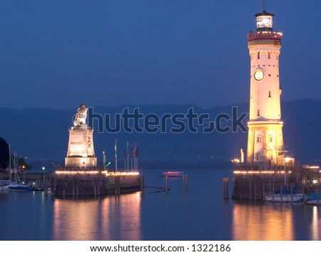 Lighthouse and Harbour entrance in Lindau, Germany. The hills in the background belong to Austria