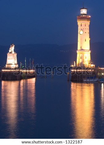 Lighthouse and Harbour entrance in Lindau, Germany. The hills in the background belong to Austria