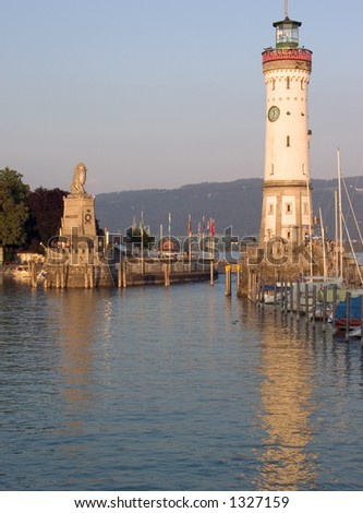 Port entrance to Lindau with lighthouse, Germany. Hills in the distance belong to Austria