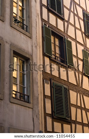 Historical Half Timbered facade under golden glow of sunset in Strasbourg.