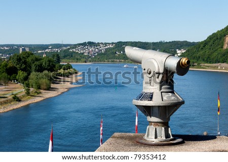 A telescope on top of an observation point at one of the most famous and scenic parts of the Rhine, the confluence with the Mosel River at Koblenz known as the German Corner (Deutsches Eck)