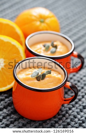 bowl of delicious pumpkin soup with orange - food and drink