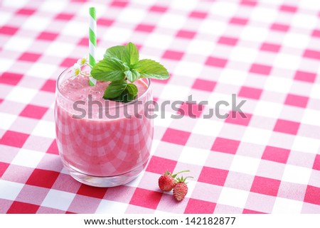 glass of delicious strawberry shake - food and drink