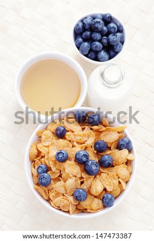 bowl of cereals with blueberry and milk - diet and breakfast