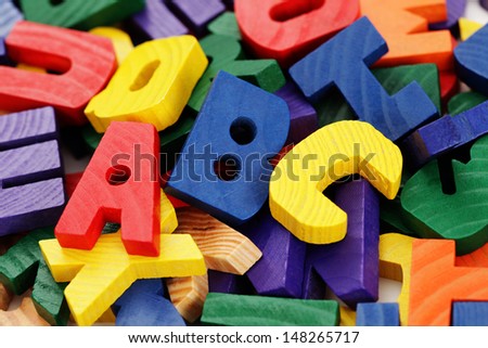 colorful wooden letters on white background - education