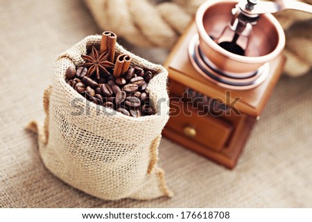 coffee grinder with coffee beans in sack - coffee time