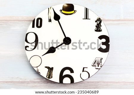 white wall clock with black number