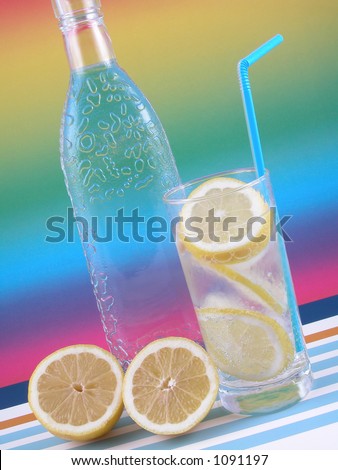 bottle of gin and iced drink on colorfull background