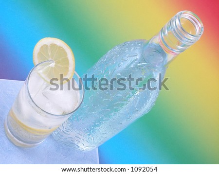 bottle of gin and iced drink on colorful background