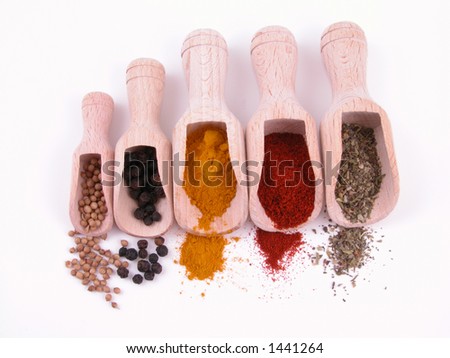 five kind of spices - turmeric paprika pepper coriander and herbs isolated on white