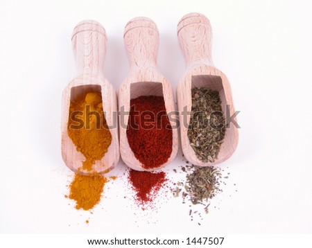 three kind of spices - turmeric paprika and herbs isolated on white