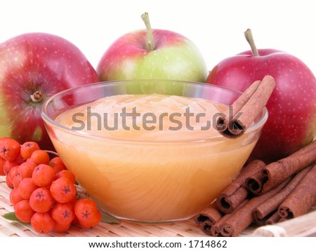 bowl of apple jam fresh apples and cinnamon sticks