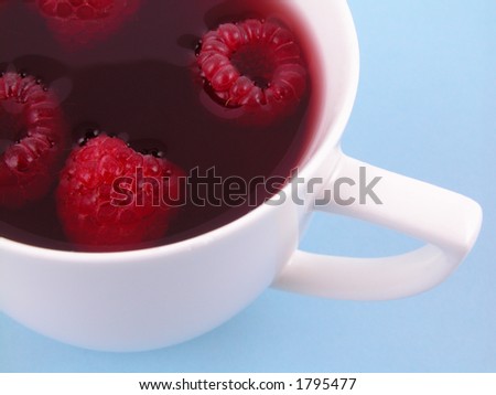 cup of tea with raspberry syrup and some fresh raspberries