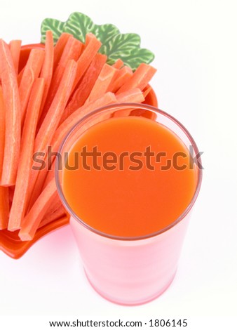 glass of carrot juice and some fresh carrots isolated on white