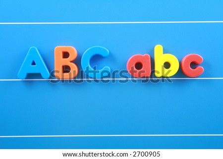 colorful letters A B C on blue board close-ups