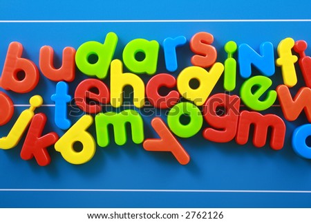 colorful letters on blue board - education concept