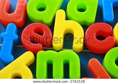 colorful letters on blue board - education concept