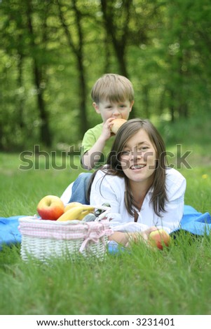 mother and son relaxing - family picnic in the forest
