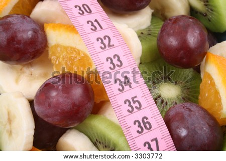 delicious fruit salad - kiwi banana orange and grapes - with measure