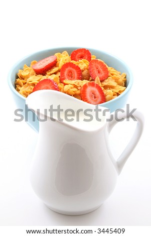 bowl of corn flakes with strawberry and jug of milk isolated on white