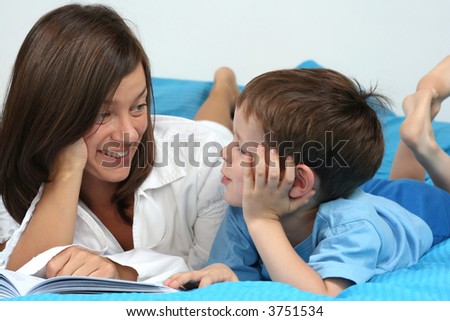 mother and five years old boy reading book - good night