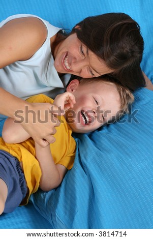 mother and three years old boy in bedroom
