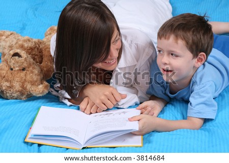 mother and five years old boy reading book - good night