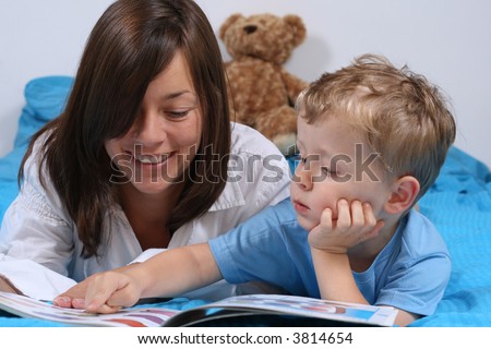 mother and three years old boy reading book - good night