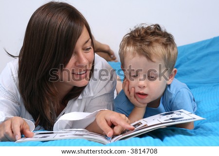 mother and three years old boy reading book - good night