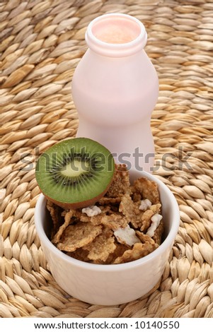 bottle of yogurt kiwi fruit and cereals