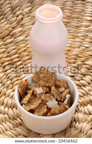 bottle of yogurt  and bowl of cereals