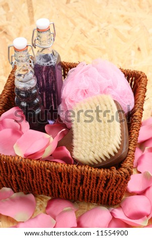 bottles of cosmetic glycerine soap and rose petals