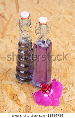 two bottles of cosmetic and orchid flower