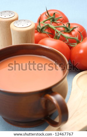 bowl of fresh tomato soup and fresh tomatoes
