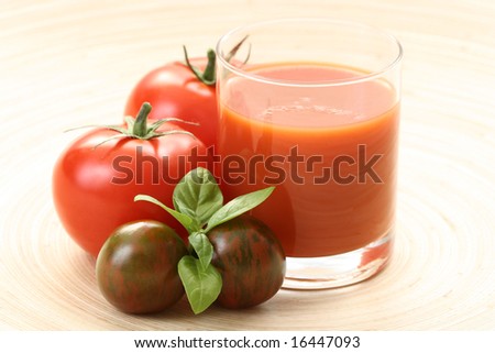glass of fresh tomato juice and some fresh tomatoes