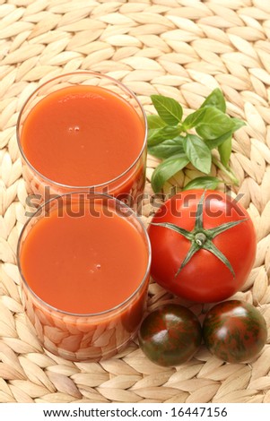 glass of fresh tomato juice and some fresh tomatoes