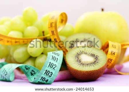 various fruits with tape measure - healthy food