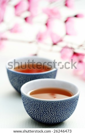 two cups of tea with pink flowers - food and drink