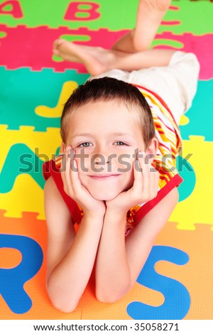 7 years old boy with colorful letters - school