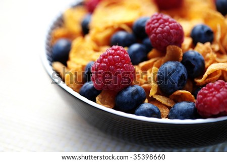bowl full of corn flakes with fruits - diet and breakfast