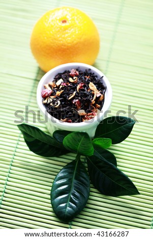 Bowl of tangerine tea with fresh fruit - tea time