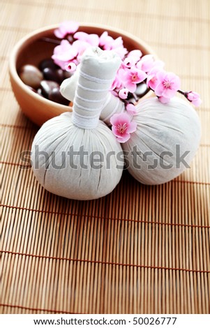 two massage stamps with bowl of stones - beauty treatment