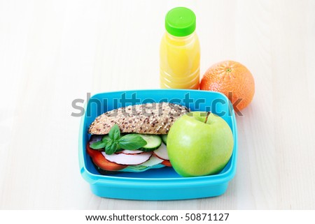lunch box with delicious sandwich and fruits - food and drink