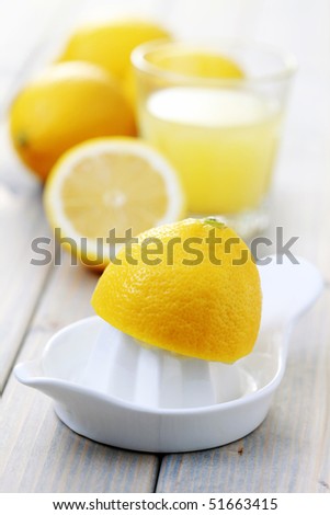 citrus squeezer and fresh lemon juice - food and drink