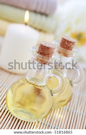 bottles of massage oil with towels - beauty treatment
