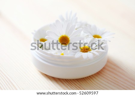 box of natural cream with chamomille flowers - beauty treatment