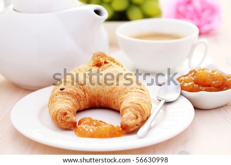 fresh croissant with jam and cup of coffee - food and drink