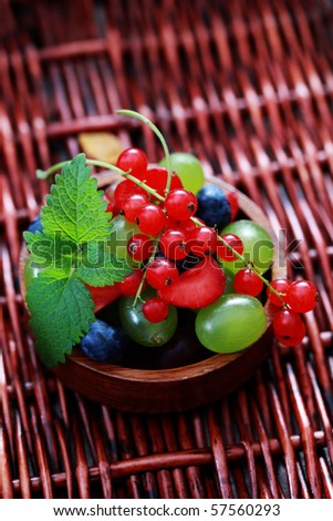 bowl of delicious berry fruits with fresh mint - fruits and vegetables